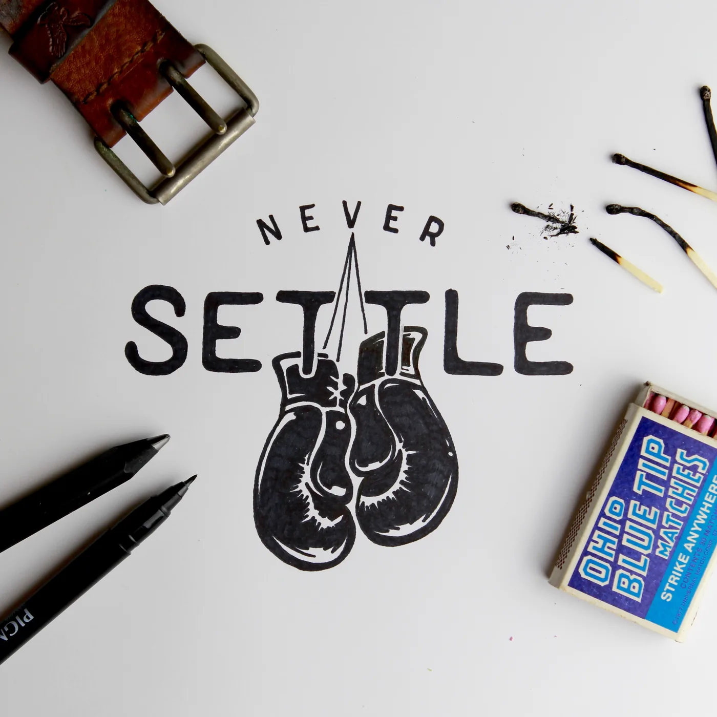 Never settle. Lettering and illustration by hand.
