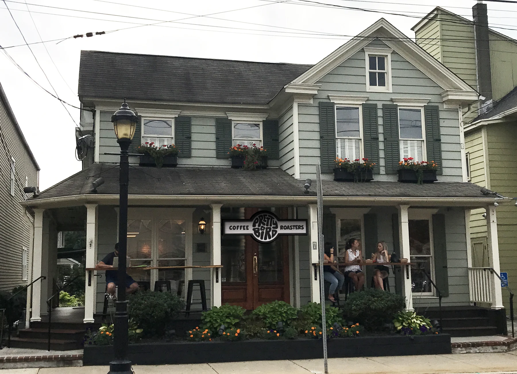 The shop with the sign in black: coffee, Pretty Bird, roasters